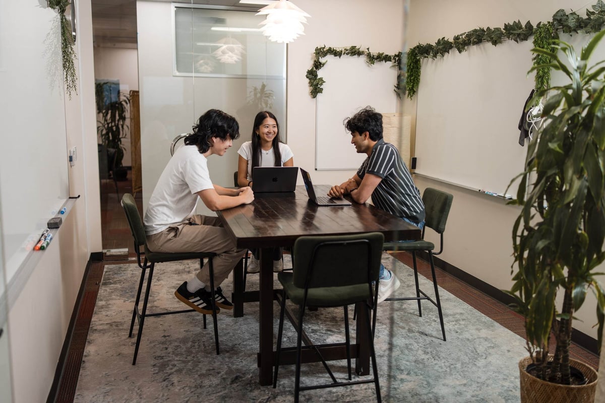 Three researchers collaborating around a table.